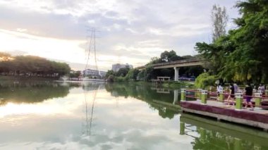 Park Lake's Bridge With A View During Sunset Hours.