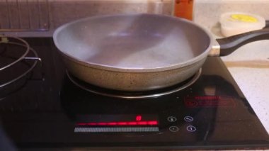 Ethnic Woman Pouring Olive Oil Into A Pan