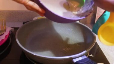 Pancake Mix Being Placed On A Frying Pan 