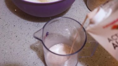  Pancake Mix Milk Being Measured By Ethnic Woman 