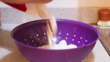 Rice Cake Getting Placed Into A Sieve 