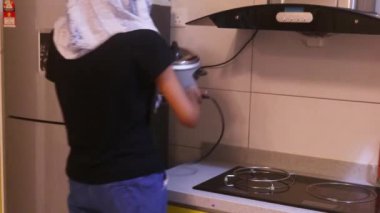 Rice Cooker Getting Plugged In By Ethnic Woman