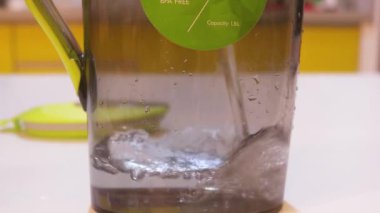 Water Getting Poured Into A Jug