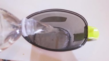 Water Getting Poured Into A Plastic Jug