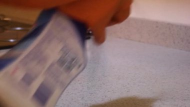 Ethnic Woman Disinfecting A Countertop With Gloves On