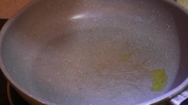 Ethnic Woman Pouring Olive Oil Into A Hot Pan