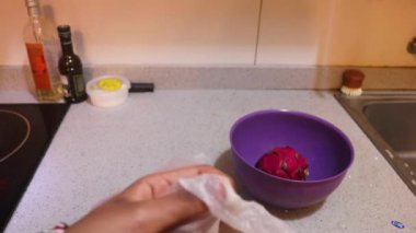 Ethnic Woman Removing Dragon Fruit From Plastic Bag 
