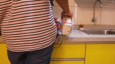 Pancake Mix Milk Being Measured By Ethnic Woman