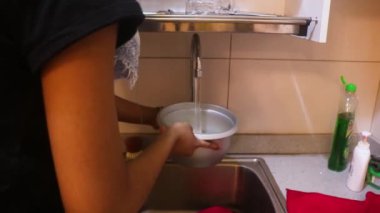 Rice Being Washed In A Pot By Ethnic Woman