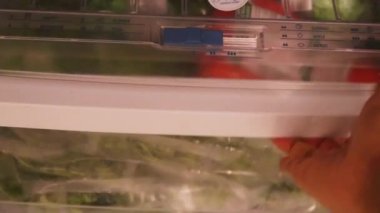 Vegetables Being Removed From A Fridge