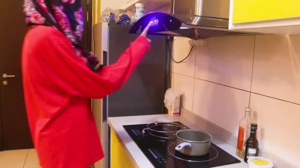 Muslim Lady Switching Exhaust Hood Side View — Stock Video