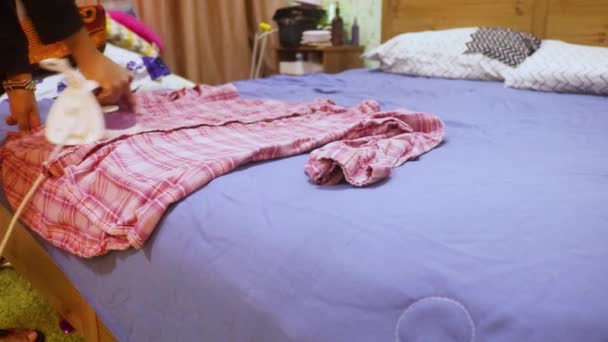 Pink Shirt Being Ironed Ethnic Woman — Stock Video