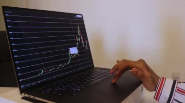 African Woman Looking At Chainlink Stock Chart Over The Years