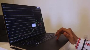 African Woman Looking At Solana Stock Chart Over The Years