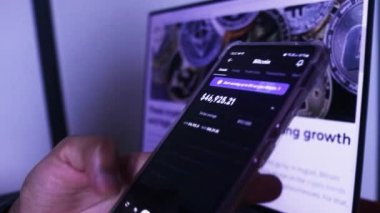 Woman Checking Real-time Updates Of Bitcoin Stocks On Mobile Phone