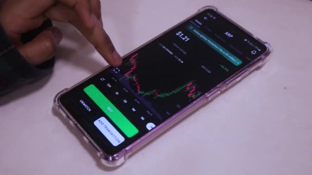 Mobile Phone Table Showing Xrp Stock Hand Scrolling — Stockvideo