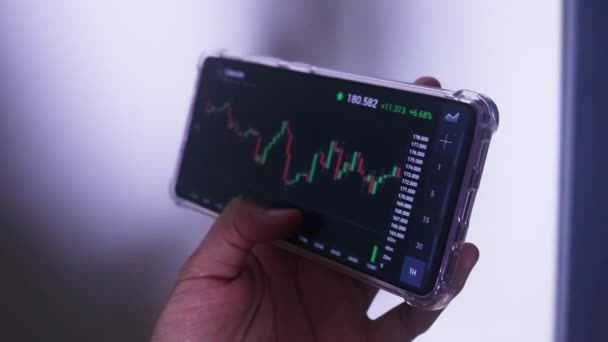 Woman Holding Phone Landscape Mode Checking Litecoin Hourly Chart — Stok Video