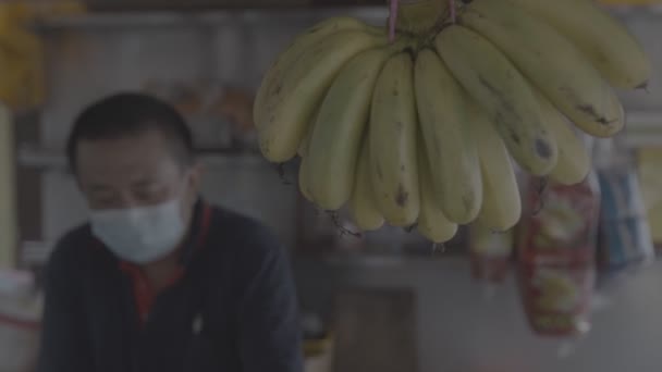 Chinese Man Fruit Stall Bananas Hanging — Stock Video