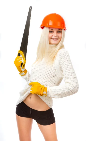 Beautiful blonde in a white sweater in orange helmet with a saw — Stock Photo, Image