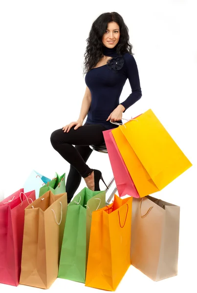 Beautiful brunette with a shopping bag on a white background. — Stock Photo, Image
