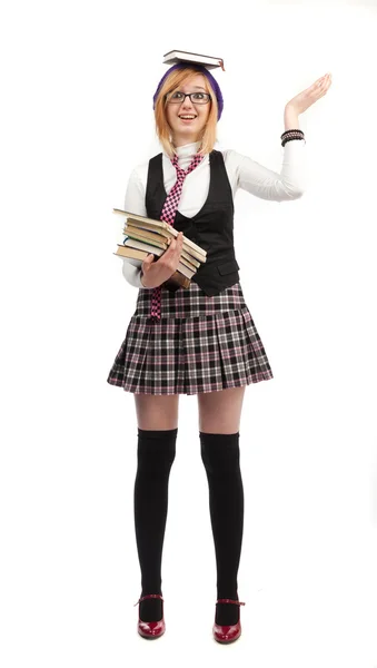 Girl with books standing on a white background — Stock Photo, Image