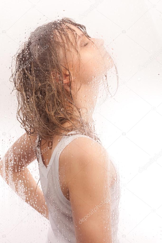 Girl wet hair with a wet glass
