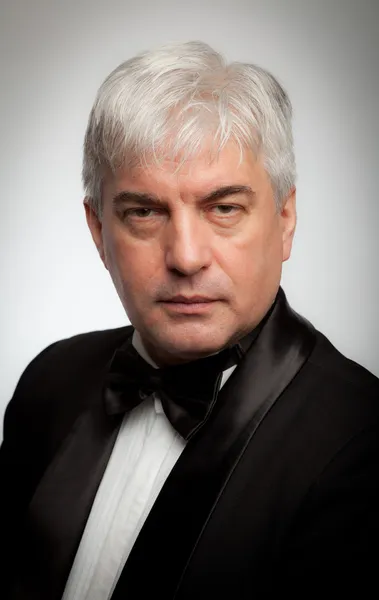 Elegant gray-haired man in a tuxedo — Stock Photo, Image