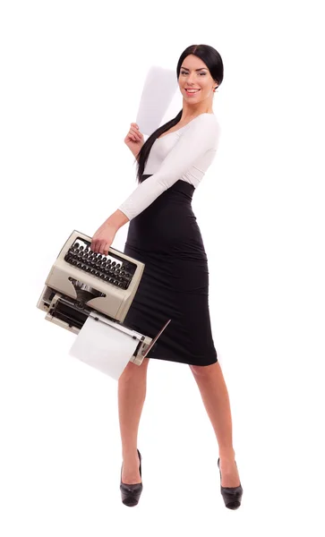 Brunette girl with a typewriter on a white background — Stock Photo, Image