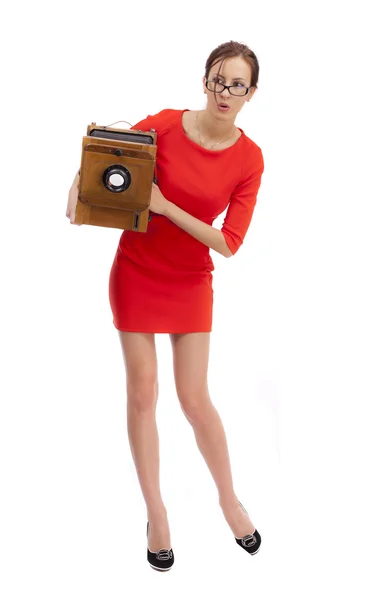 Girl in red dress with an old camera — Stock Photo, Image