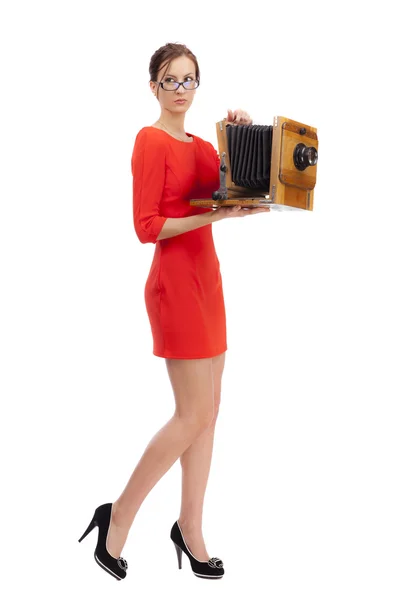 Girl in red dress with an old camera — Stock Photo, Image