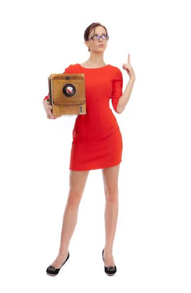 Girl in red dress with an old camera — Stock Photo, Image