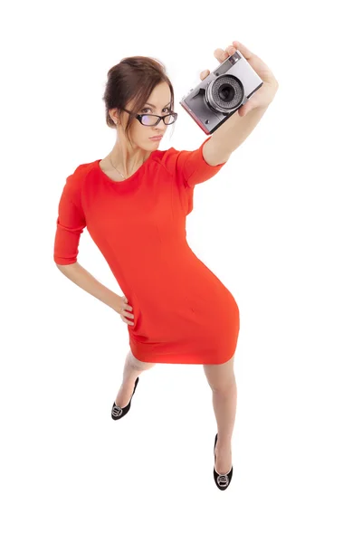 Girl in a red dress with shiny camera — Stock Photo, Image
