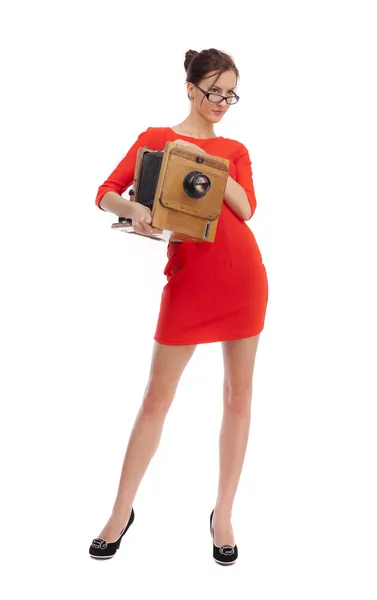 Girl in red dress with an old camera — Stock Photo, Image