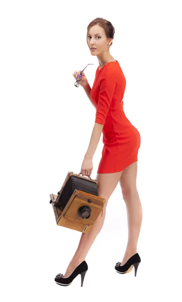 Girl in red dress with an old camera — Stock Photo, Image