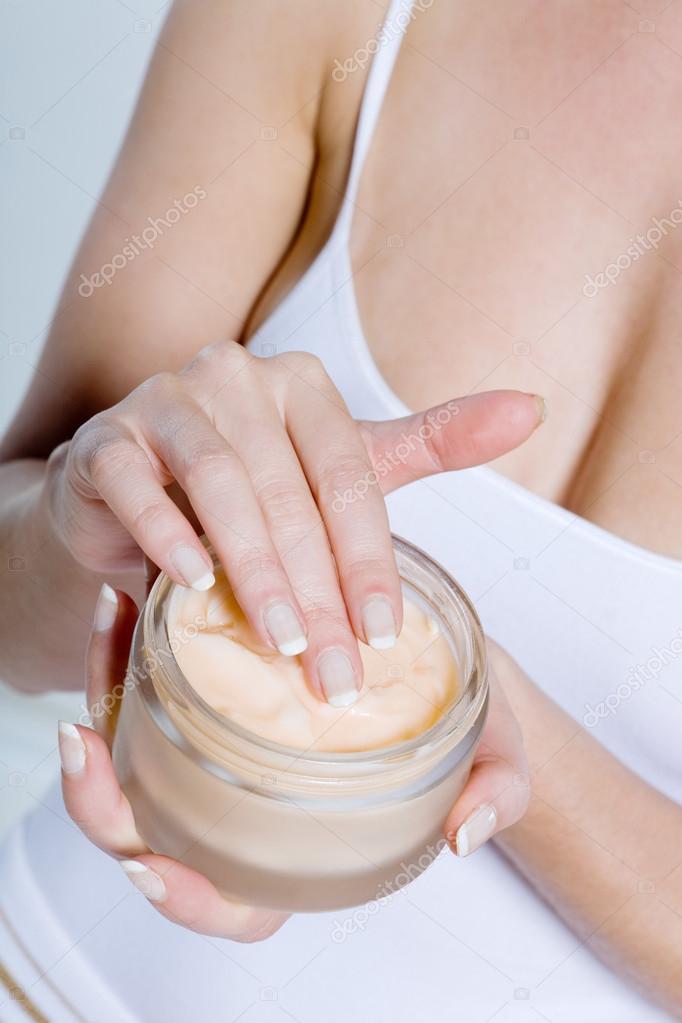woman hands applying mosturiser cream lotion bodycare