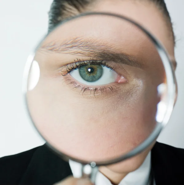 Curious woman looking eyes through magnifying glass — Stock Photo, Image
