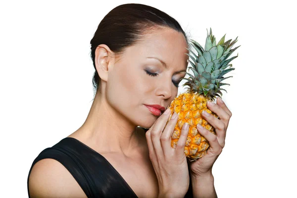 Closeup portrait of beautiful woman smelling pineapple with eyes — Stock Photo, Image