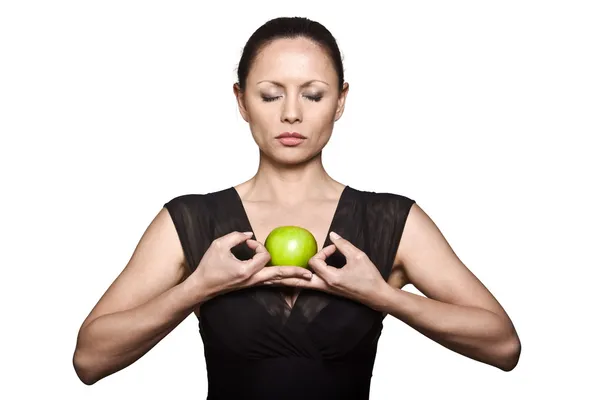 Beautiful Asian woman with green apple meditating — Stock Photo, Image