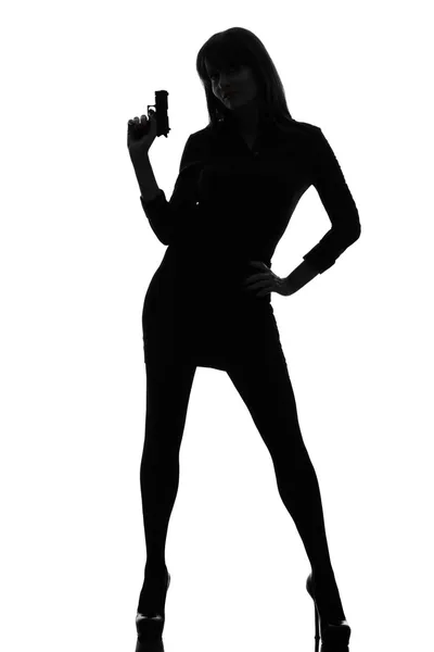 Sexy detetive mulher segurando apontando arma silhueta — Fotografia de Stock