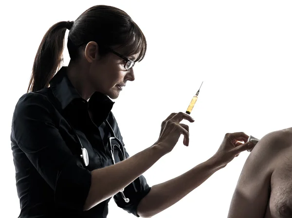 Woman doctor holding surgical needle vaccination silhouette — Stock Photo, Image