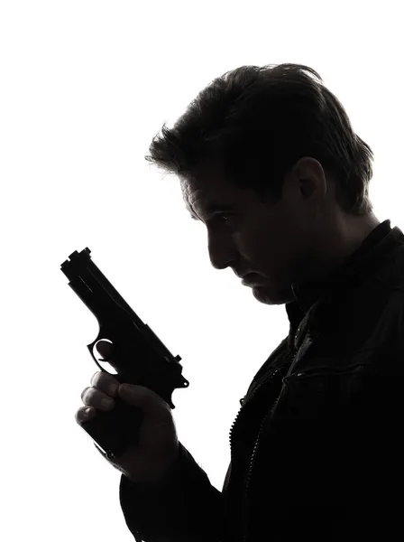 Hombre asesino policía sosteniendo pistola retrato silueta —  Fotos de Stock