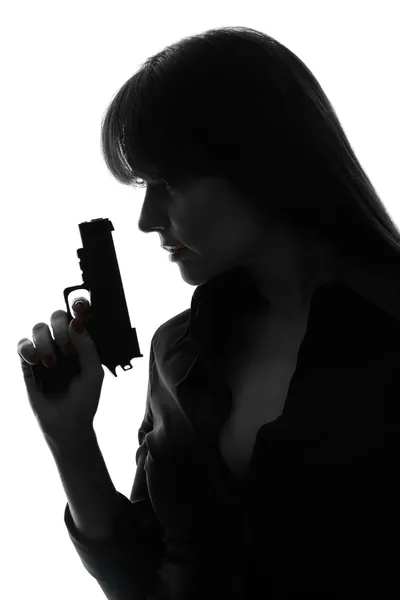 Sexy detective woman holding gun silhouette — Stock Photo, Image