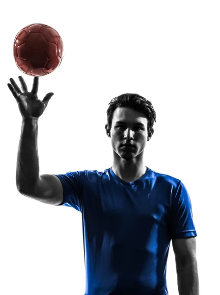 Jovem homem exercitando silhueta jogador de handebol — Fotografia de Stock