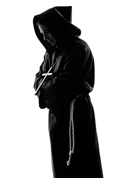 Силуэт монаха, молящегося — стоковое фото