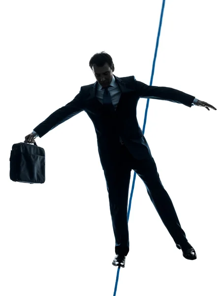 Businessman tightrope walker silhouette — Stock Photo, Image