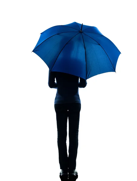 Woman rear view holding umbrella silhouette — Stock Photo, Image