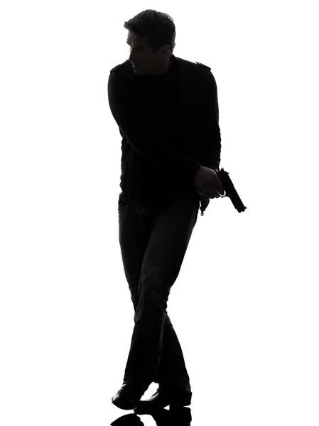 Man killer policeman holding gun walking silhouette — Stock Photo, Image