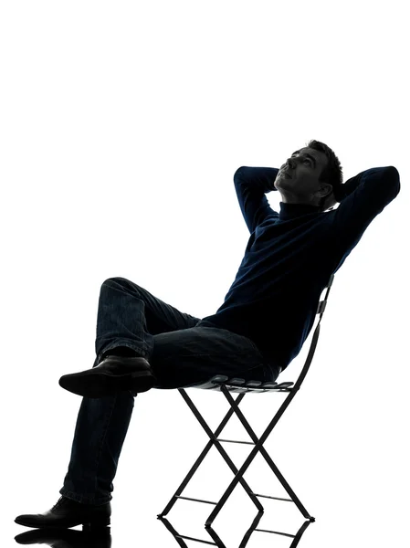 Man sitting resting looking up silhouette full length — Stock Photo, Image