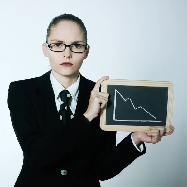 Serious business woman holding graphic board with deacreasing cu — Stock Photo, Image