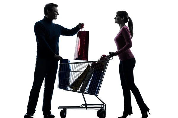 Couple woman man with shopping cart and gifts silhouette — Stock Photo, Image